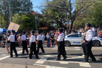 Sydney Uni Marching Band marching past onlookers at Granny Smith Festival